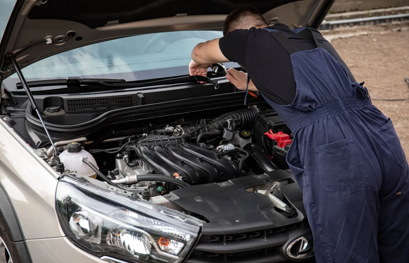 Mechanic checking a car at an outdoor location