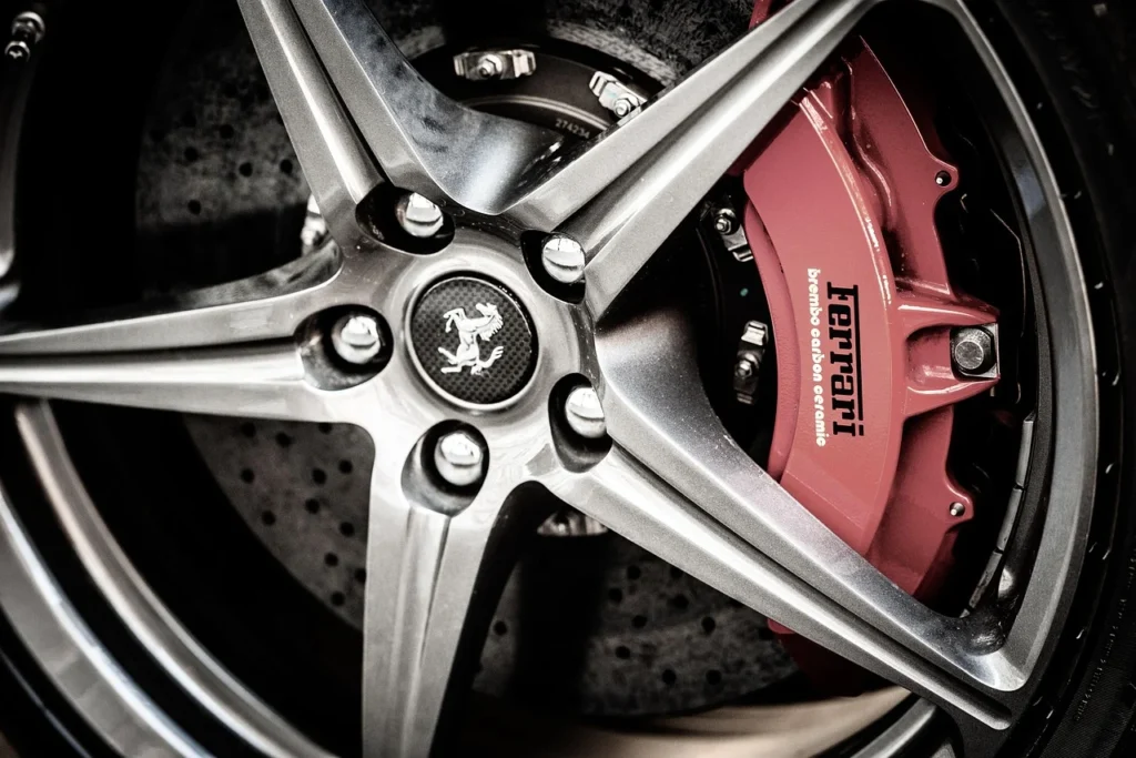 Brake caliper removed from a car wheel during a repair