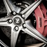Brake caliper removed from a car wheel during a repair