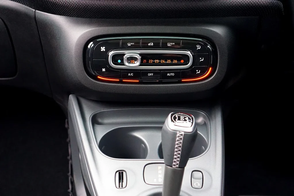 Car heater temperature dial and dashboard controls set to warm