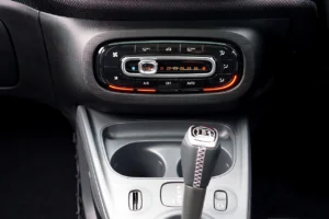 Car heater temperature dial and dashboard controls set to warm