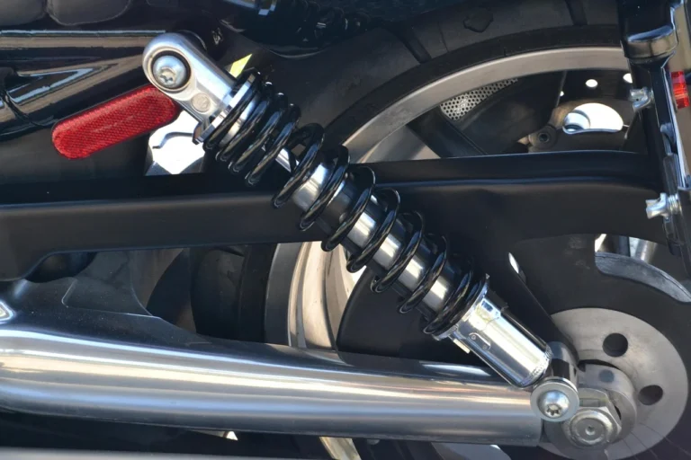 Mechanic inspecting a car shock absorber and suspension component