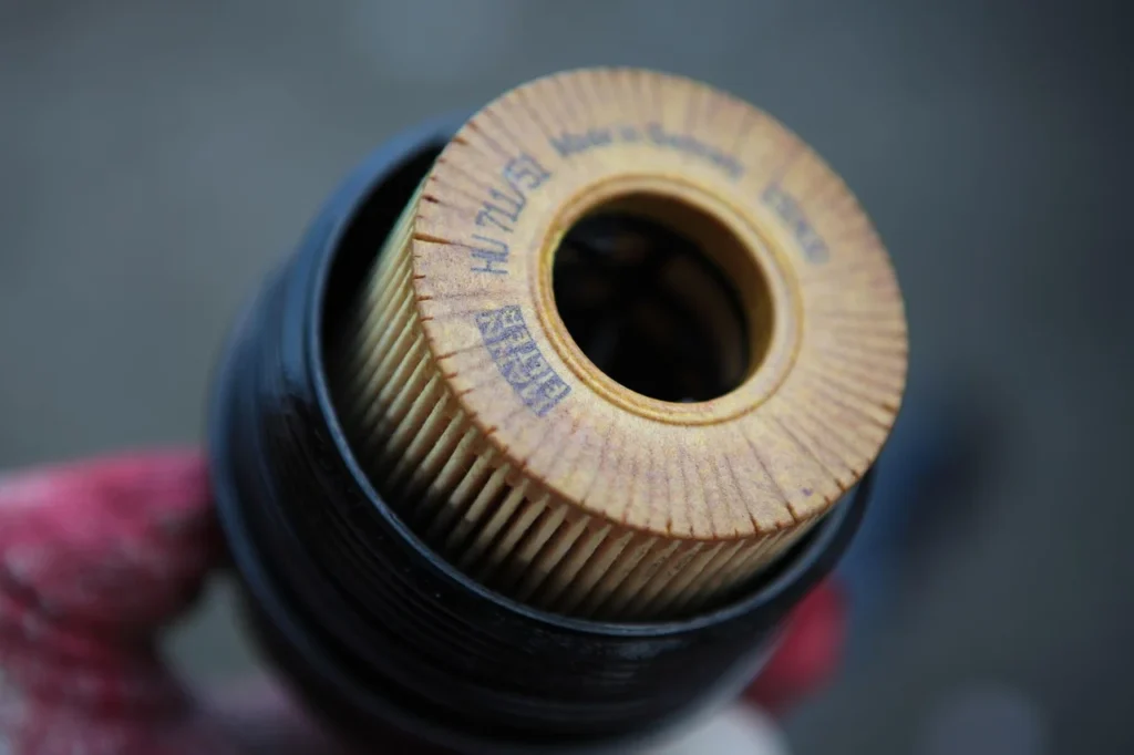 Checking car engine oil with dipstick