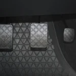 Close-up of a manual car clutch pedal inside the driver footwell