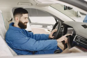 Driver comparing marketplace quotes on a phone beside an SSK Mechanics van