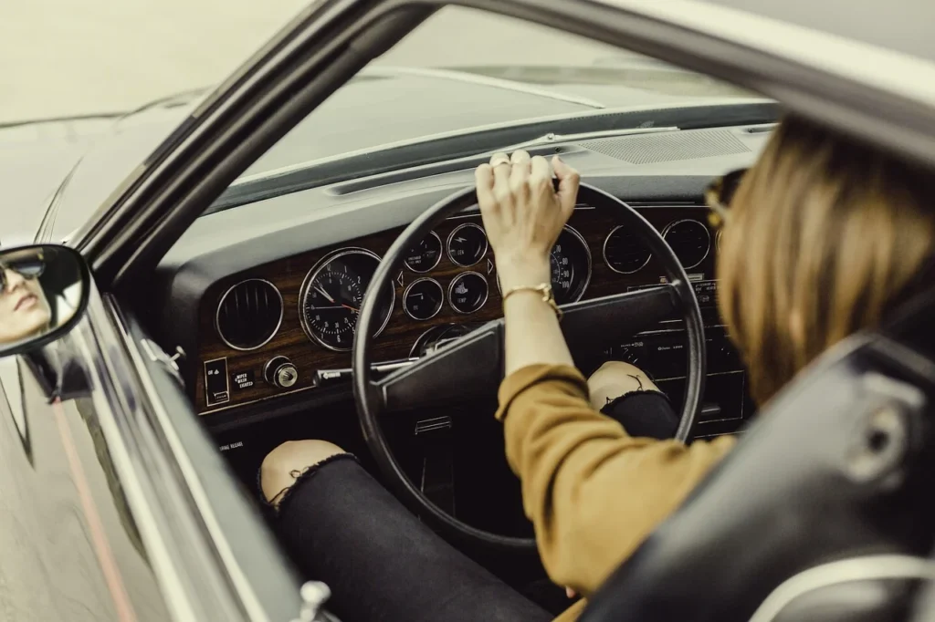 A driver changing gear smoothly with the fuel gauge visible on the dashboard