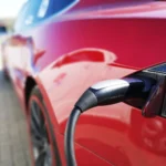 Charging cable plugged into electric car battery