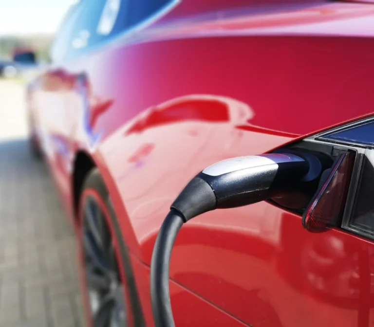 Charging cable plugged into electric car battery
