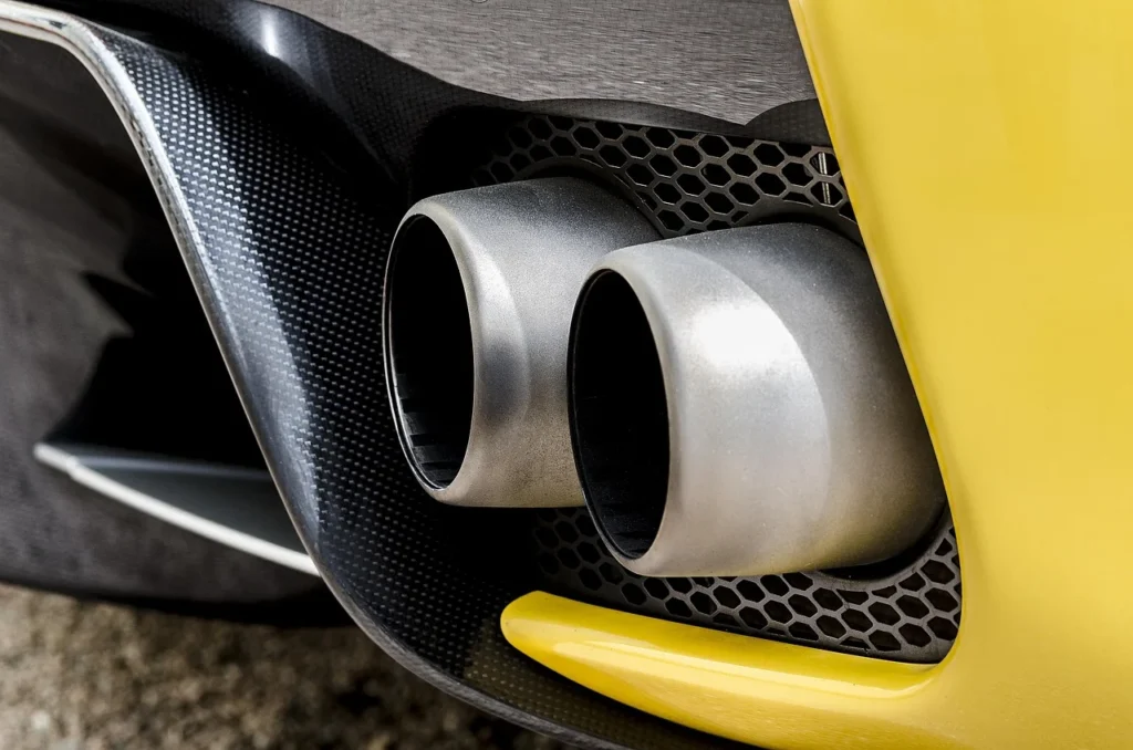 Mechanic carrying out an exhaust emissions test using a smoke meter