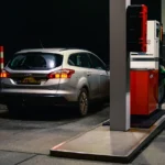 A close up of a fuel pump nozzle at a filling station, illustrating a misfuelling risk