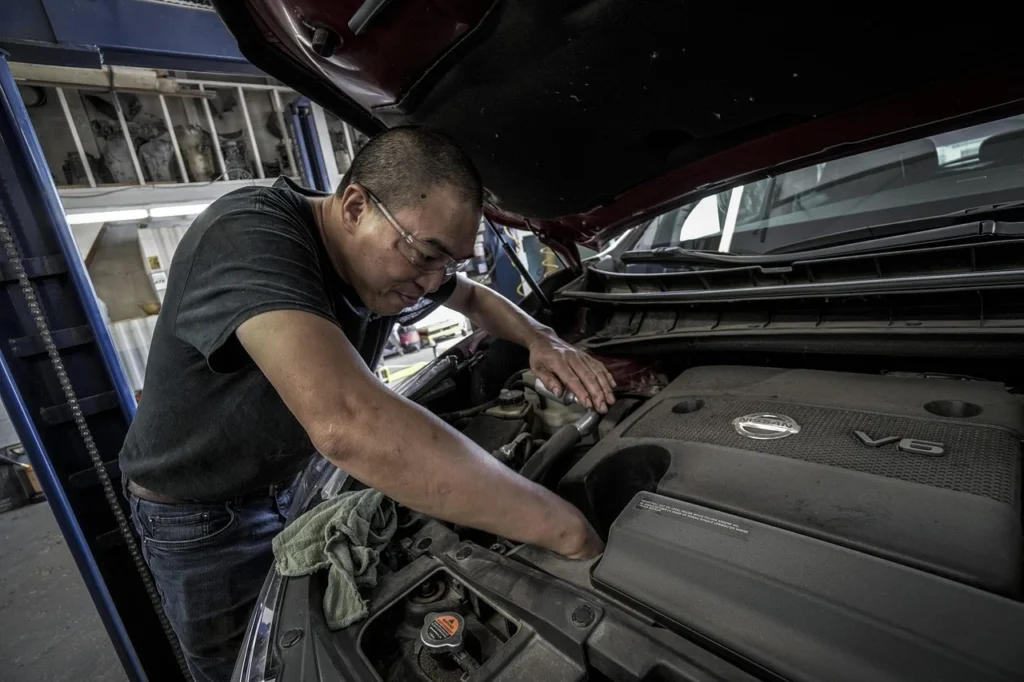 Mechanic doing pre-purchase inspection with checklist
