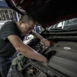 Mechanic doing pre-purchase inspection with checklist