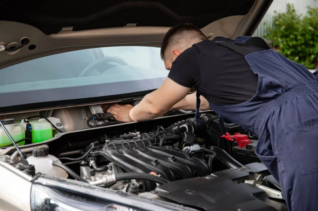 Mobile mechanic servicing a car outside a rural West Yorkshire home