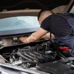 Mobile mechanic servicing a car outside a rural West Yorkshire home