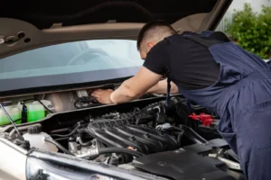 Mobile mechanic servicing a car outside a rural West Yorkshire home