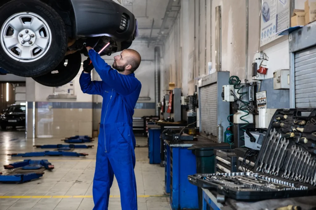 Car being inspected during an MOT test in a test centre bay