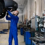 Car being inspected during an MOT test in a test centre bay