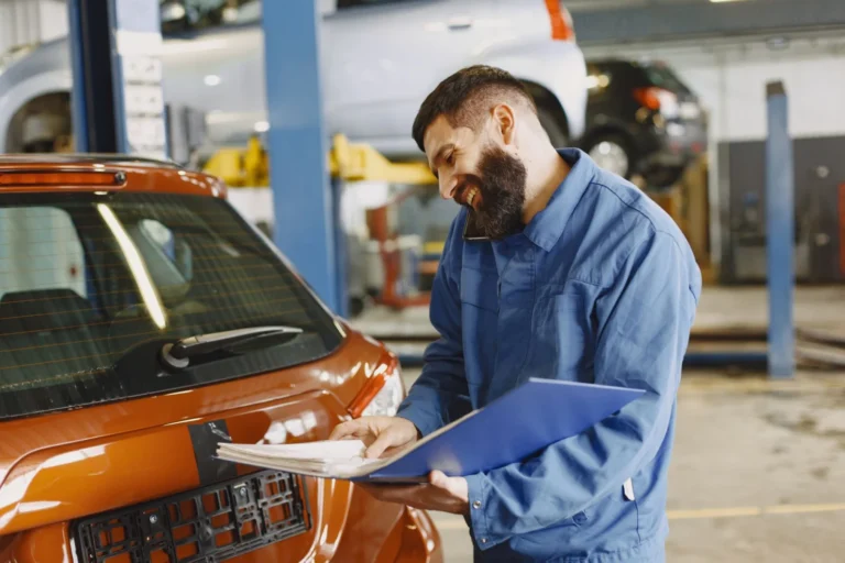 Driver comparing a mobile mechanic quote against a marketplace listing on a laptop