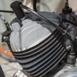 New spark plug being fitted into a car engine cylinder