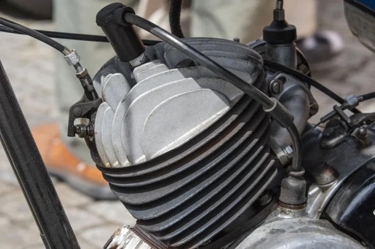 New spark plug being fitted into a car engine cylinder