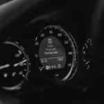 Close-up of a car dashboard in black and white with a parking lamp warning light — SSK Mechanics guide to SEAT Leon Petrol, Diesel and e-HYBRID Warnings