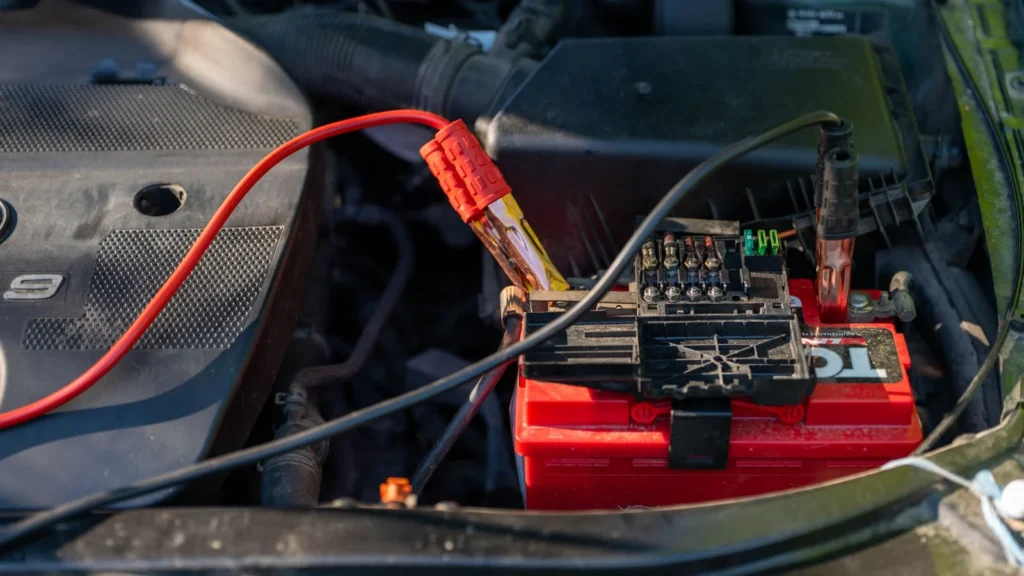 Close-up of a car battery with attached jumper cables in an engine bay — SSK Mechanics guide to Nissan Qashqai Battery Check and Car-Not-Starting Guide