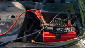 Close-up of a car battery with attached jumper cables in an engine bay — SSK Mechanics guide to Nissan Qashqai Battery Check and Car-Not-Starting Guide