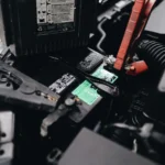 Detailed view of a car battery being jump-started with cables in an engine bay — SSK Mechanics guide to MINI Hatch Battery Check and Car-Not-Starting Guide