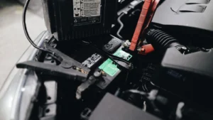 Detailed view of a car battery being jump-started with cables in an engine bay — SSK Mechanics guide to MINI Hatch Battery Check and Car-Not-Starting Guide