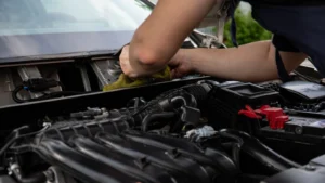 Close-up of a mechanic working on a car engine, showcasing hands and engine details — SSK Mechanics guide to BMW 3 Series Battery Check and Car-Not-Starting Guide