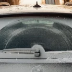 Close-up of a frosted car rear window showing unique patterns created by snowfall and a wiper — SSK Mechanics guide to Fiat 500 Wipers, Bulbs and Fuse Changes