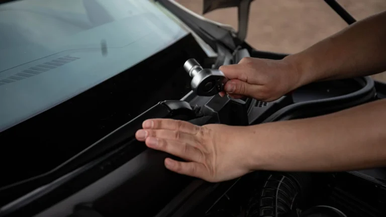 Mechanic using socket wrench to repair car engine outdoors, showcasing hands-on automotive work — SSK Mechanics guide to Kia Sportage Oil Change or Full Service