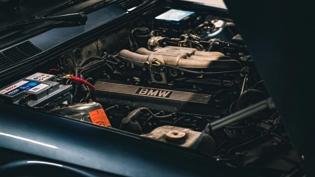 Detailed view of a BMW car engine with visible battery, showcasing mechanical intricacies in a… — SSK Mechanics guide to Nissan Juke Battery Check and Car-Not-Starting Guide