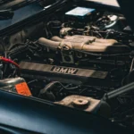 Detailed view of a BMW car engine with visible battery, showcasing mechanical intricacies in a… — SSK Mechanics guide to Nissan Juke Battery Check and Car-Not-Starting Guide