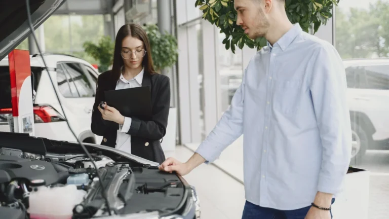 Man and woman examining car engine in dealership service area, focused on vehicle maintenance… — SSK Mechanics guide to BMW 1 Series Oil Change or Full Service