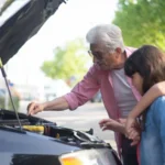 Grandfather shows his grandchildren car engine mechanics outdoors, teaching them about car… — SSK Mechanics guide to Honda Jazz Oil Change or Full Service