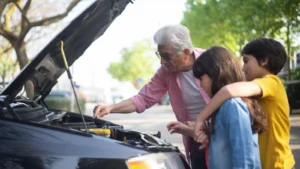 Grandfather shows his grandchildren car engine mechanics outdoors, teaching them about car… — SSK Mechanics guide to Honda Jazz Oil Change or Full Service