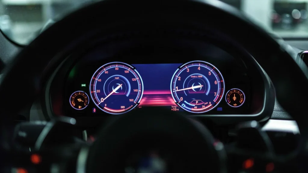 Close-up of a car dashboard with illuminated gauges displaying speed and RPM — SSK Mechanics guide to VW Tiguan Warning-Light and Diagnostics Guide