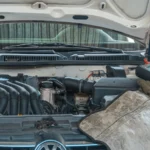 Close-up of a Volkswagen car engine undergoing repair in a garage, tools and diagnostic… — SSK Mechanics guide to Toyota Aygo Battery Check and Car-Not-Starting Guide