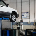A car is elevated on a lift in a modern automotive repair shop, showcasing tools and equipment — SSK Mechanics guide to Toyota Aygo Oil Change or Full Service