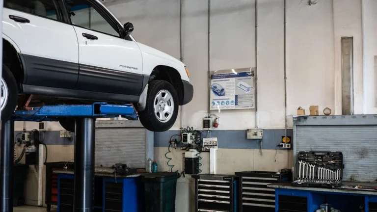 A car is elevated on a lift in a modern automotive repair shop, showcasing tools and equipment — SSK Mechanics guide to Toyota Aygo Oil Change or Full Service