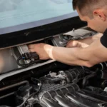 Mechanic focusing on car engine repair, showcasing skill and precision — SSK Mechanics guide to Land Rover Discovery Starter Motor or Alternator