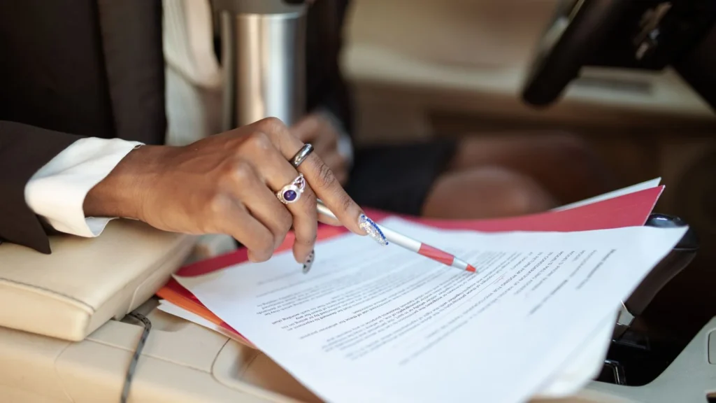 Finance agreement being reviewed inside a vehicle before disposal