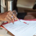 Finance agreement being reviewed inside a vehicle before disposal