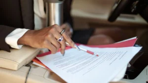 Finance agreement being reviewed inside a vehicle before disposal
