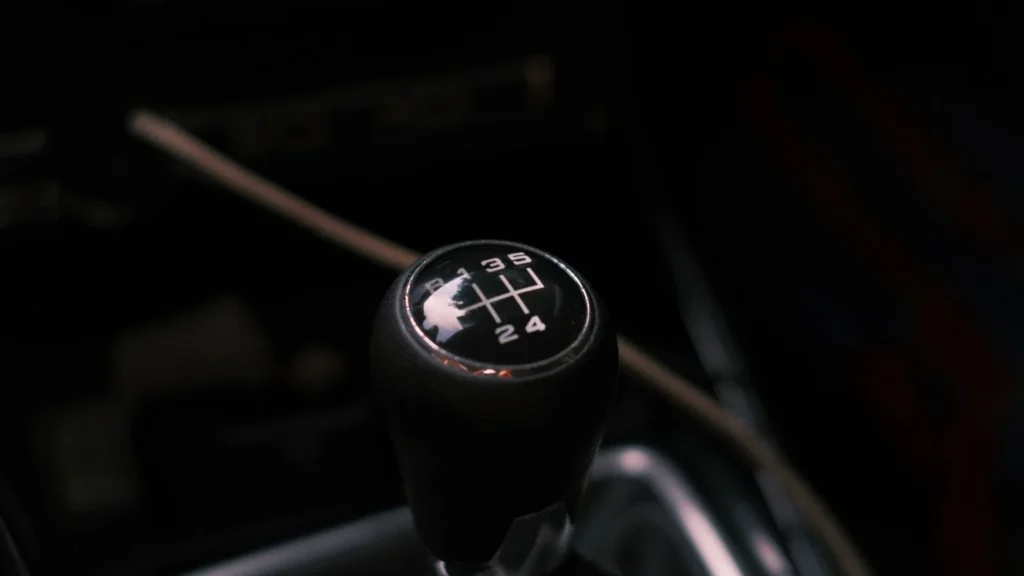 Detailed view of a car's manual transmission shift knob with visible gear pattern — SSK Mechanics guide to Why Does My Car Judder When Pulling Away