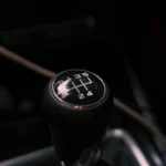 Detailed view of a car's manual transmission shift knob with visible gear pattern — SSK Mechanics guide to Why Does My Car Judder When Pulling Away