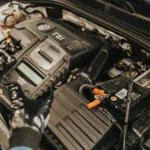 Close-up view of a mechanic diagnosing a Volkswagen engine with specialized equipment — SSK Mechanics guide to Why Does My Engine Cut Out While Driving