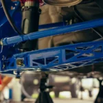 Detailed view of a blue custom car suspension part in an auto garage — SSK Mechanics guide to Tie Rod End Replacement Cost: Why It's Rarely Sold on Its Own