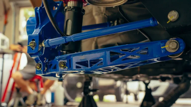 Detailed view of a blue custom car suspension part in an auto garage — SSK Mechanics guide to Tie Rod End Replacement Cost: Why It's Rarely Sold on Its Own